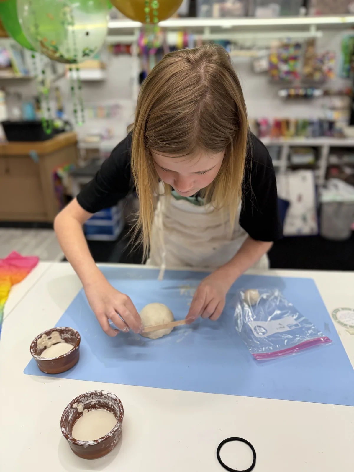 An artist using a brayer during a printmaking experiment