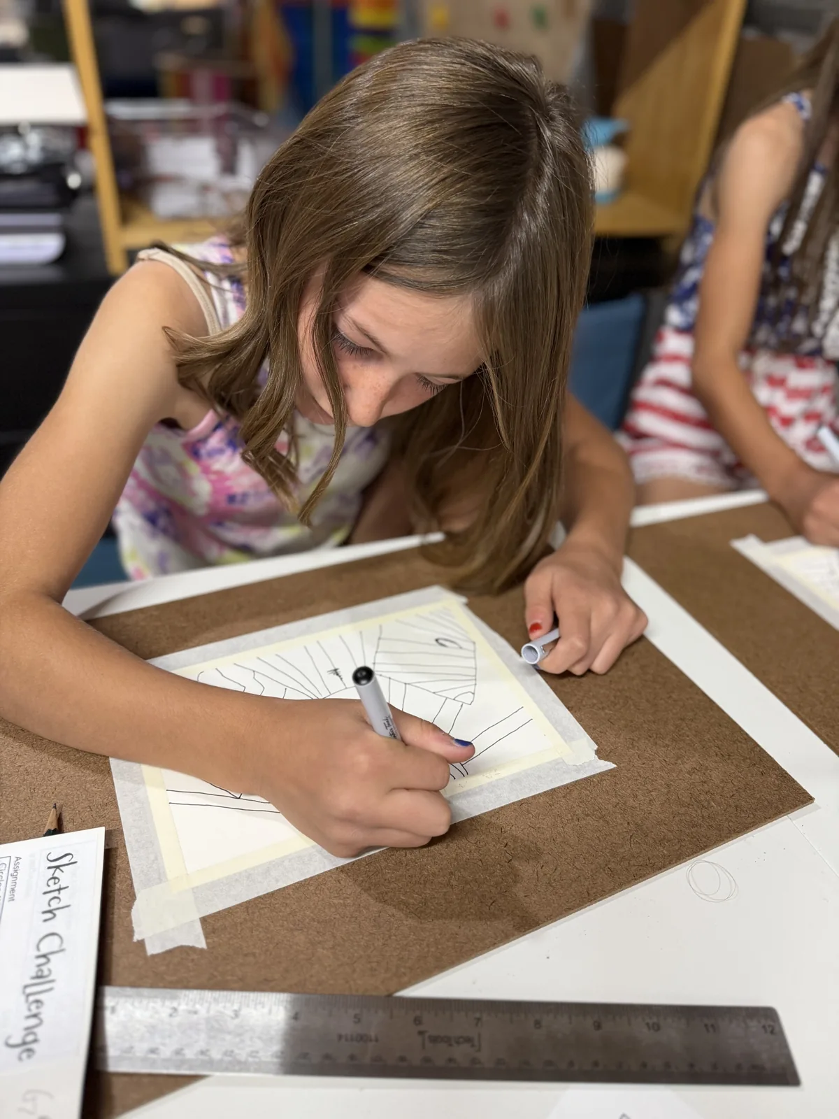 An artist carefully developing a pencil drawing in a sketchbook