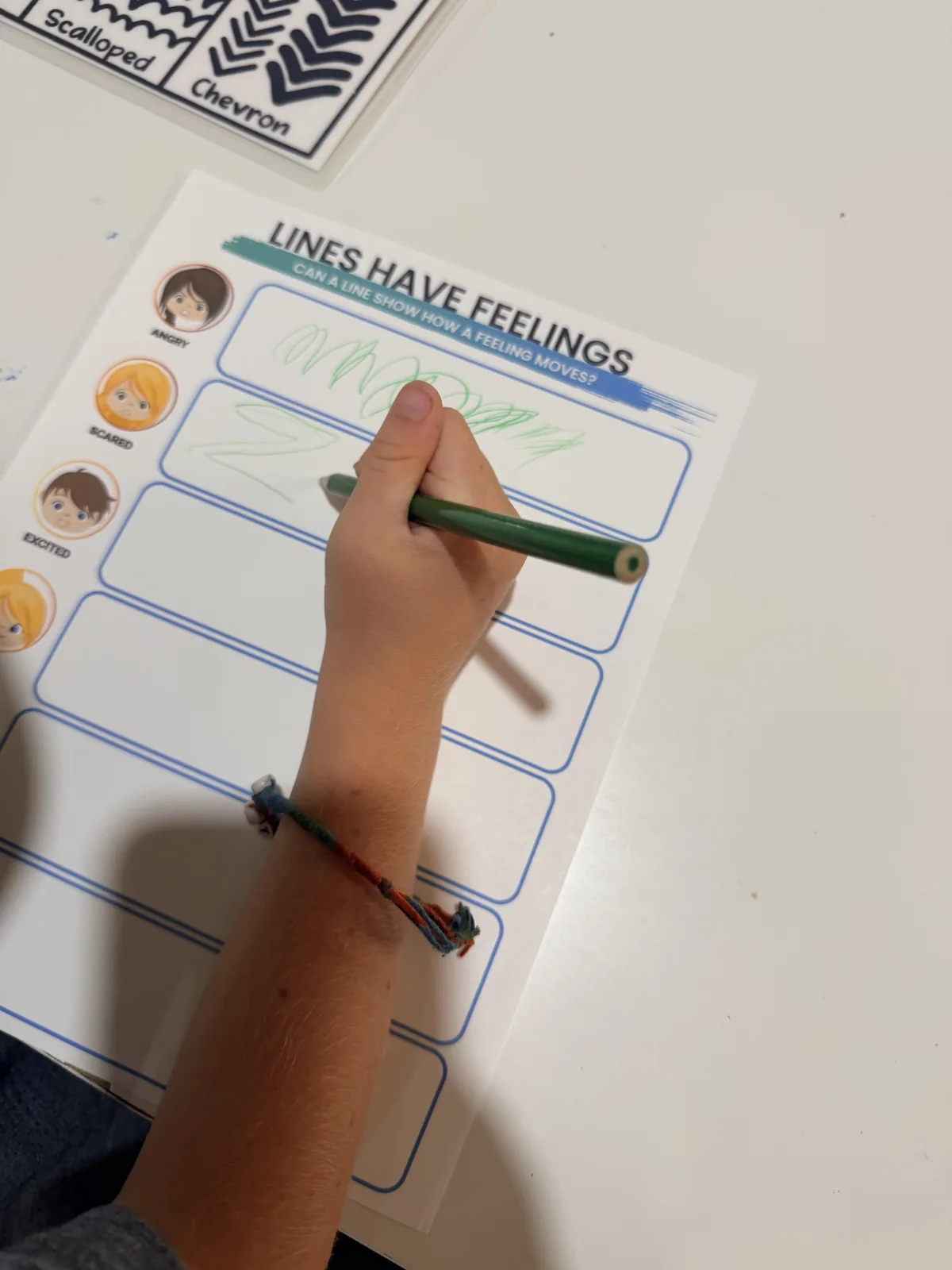 A child exploring expressive lines on a Creative Roots learning page