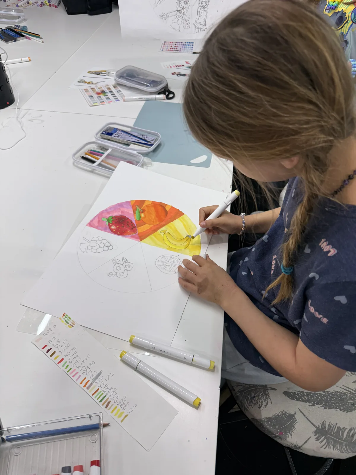 An artist painting a segmented circular watercolor study